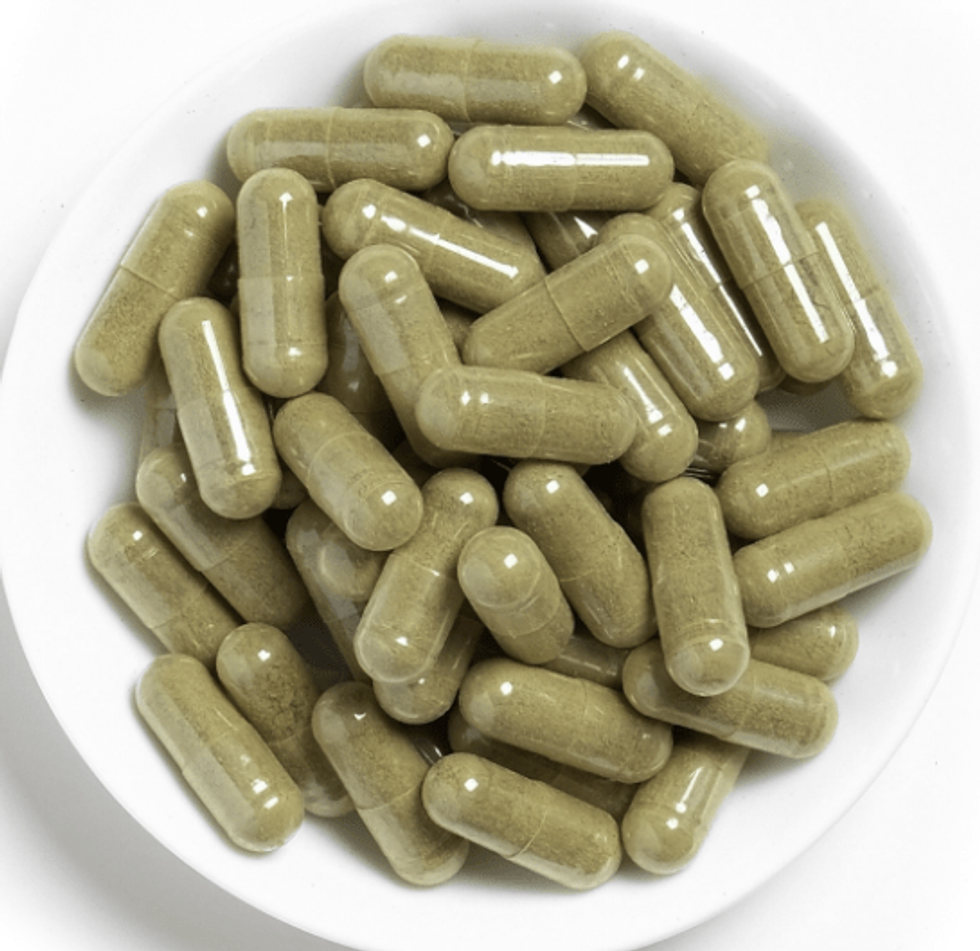 Kratom capsules in a bowl