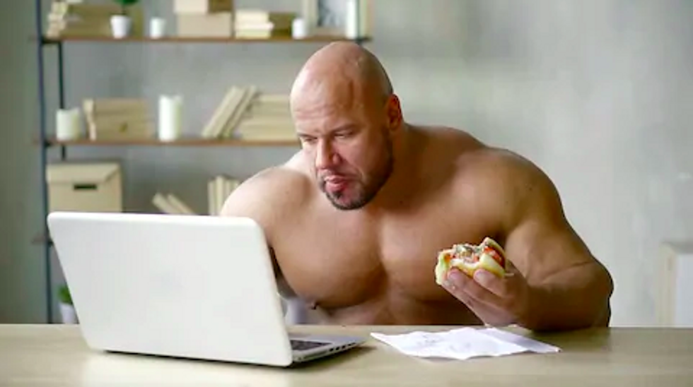 Jacked man eating burger