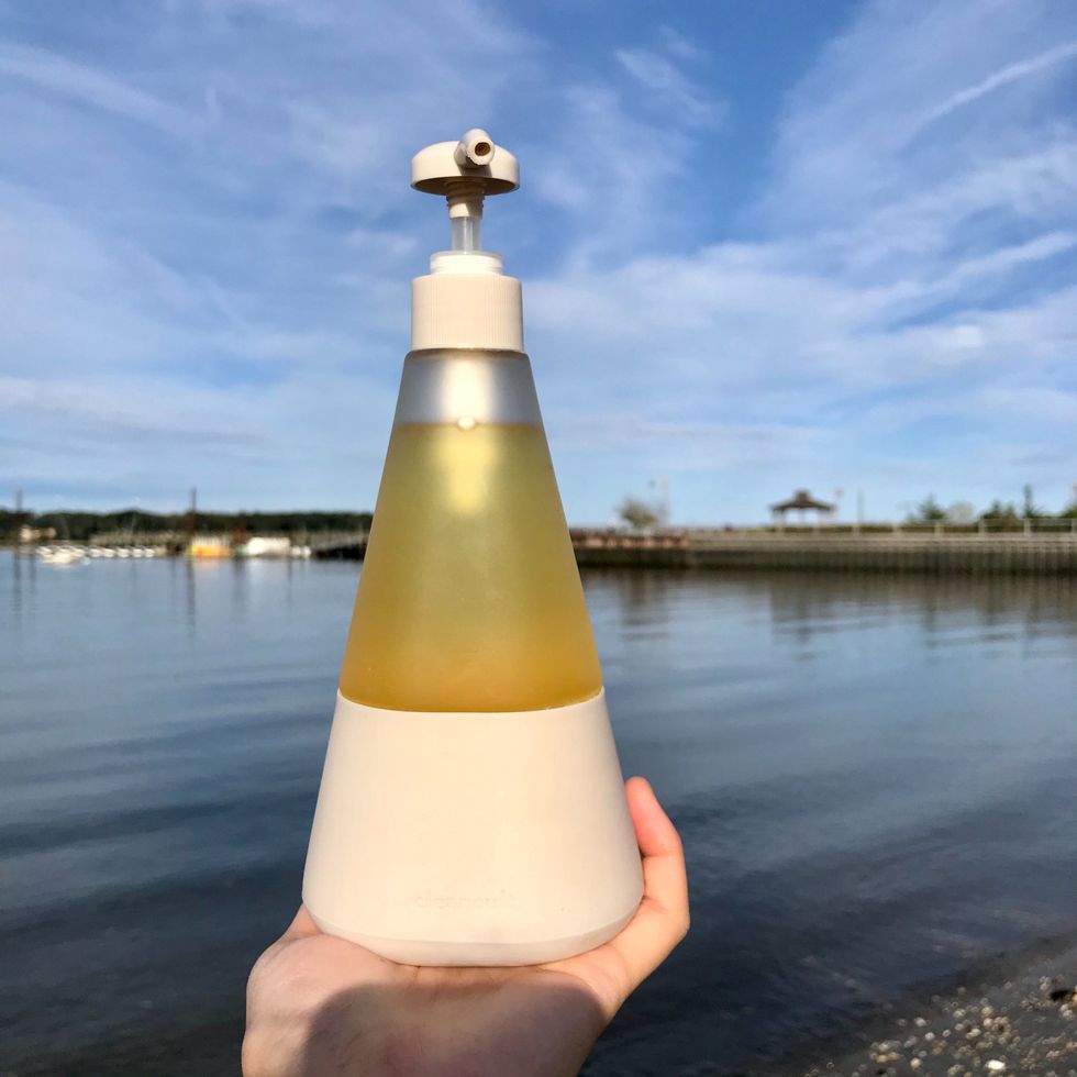 cleancult liquid dish soap in glass bottle in front of ocean