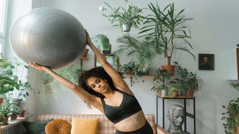 man sitting on yoga ball